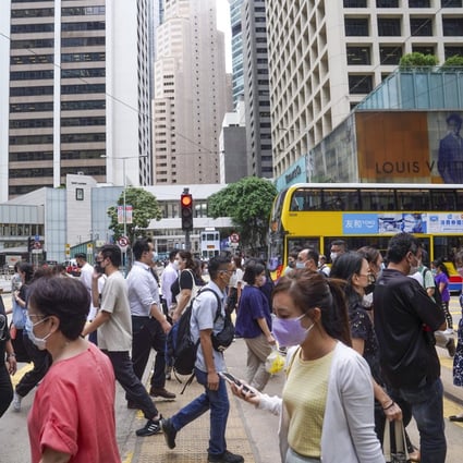 People crossing the street at Central district on October 7, 2021. Hong Kong consumers have become more health conscious during the most recent coronavirus wave, helping boost insurance sales in the first quarter. Photo: SCMP / Sam Tsang