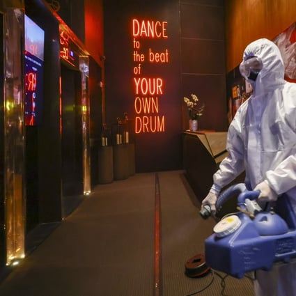 Cleaners disinfect Zentral club in the California Tower in Lan Kwai Fong, following an outbreak of Covid-19 cases at the club. Photo: Dickson Lee