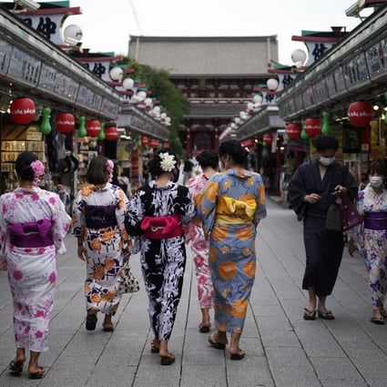Tourists in traditional Japanese kimonos in Tokyo; there are concerns about Covid-19 spike as Japan opens its borders. Photo: AP 