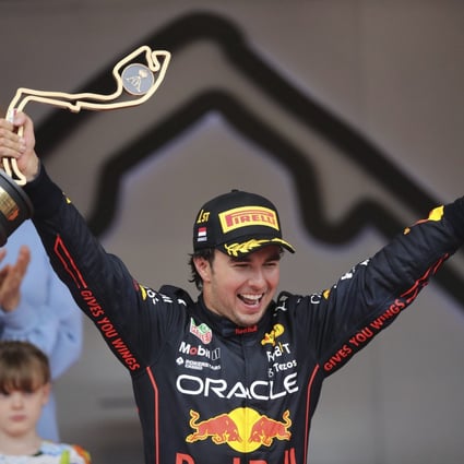 Red Bull driver Sergio Perez of Mexico celebrates on the podium after winning the Monaco F1 Grand Prix. Photo: AP