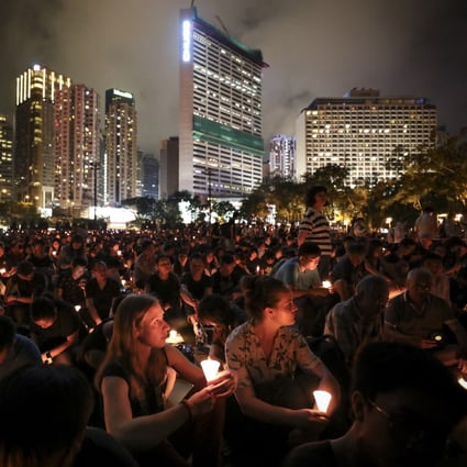 Crowds in 2019 hold up candles in a June 4 vigil at Victoria Park. The event has since been banned on health grounds. Photo: James Wendlinger