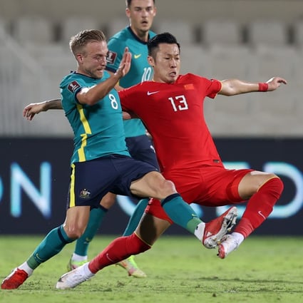 Xu Xin of China vies with James Jeggo of Australia during the 2022 FIFA World Cup Asian qualifiers in Sharjah. Photo: Xinhua