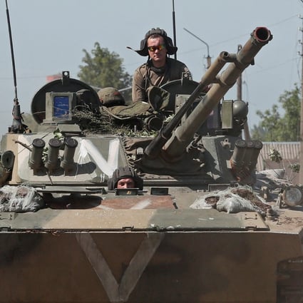 Pro-Russian troops ride an infantry fighting vehicle in the town of Popasna in the Luhansk region, Ukraine. Photo: Reuters