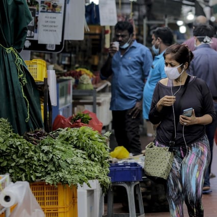 People at a vegetable stall in Singapore. Photo: EPA-EFE