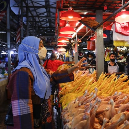 A woman shops at at wet market in Kuala Lumpur. Photo: EPA-EFE 