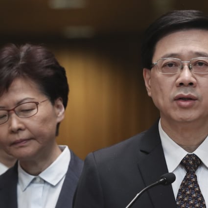 Chief Executive Carrie Lam listens as then secretary for security John Lee speaks to the media at the Chief Executive’s Office in Tamar on July 21, 2019. Photo: Robert Ng