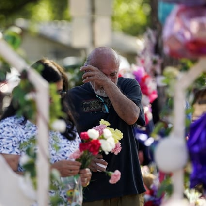 Visitors pay their respects at a memorial created to honour the victims of last week’s school shooting in Uvalde, Texas. Photo: AP