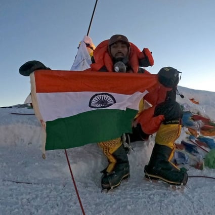 Narender Singh Yadav poses with India’s national flag at the summit of Mount Everest on May 27. Photo: Pioneer Adventure Pvt Ltd / AFP