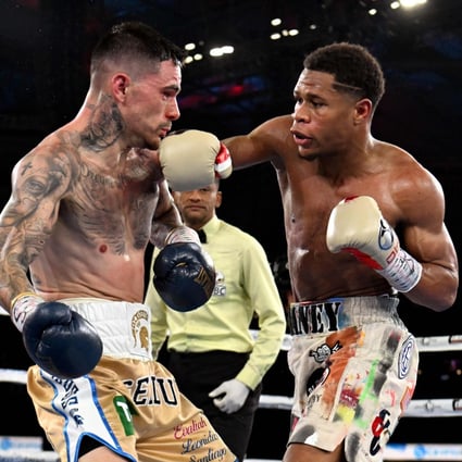 Devin Haney (right) connects with a right against George Kambosos during their lightweight title fight in Melbourne. Photo: AFP
