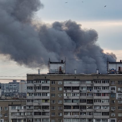 Smoke rises from a building in Kyiv on Sunday after the Russian missile strikes. Photo: Reuters