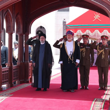 Oman’s Sultan Haitham bin Tariq stands with Iran’s President Ebrahim Raisi during a welcoming ceremony in Muscat, Oman, on May 23. Photo: Official Presidential Website / Handout via Reuters