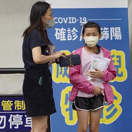 A mother takes her daughter to a special paediatric clinic in Kaohsiung, Taiwan on Wednesday. Photo: CNA