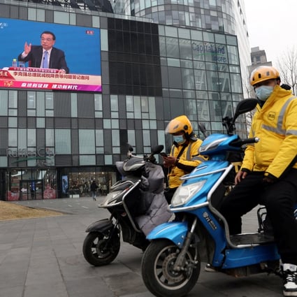 After Premier Li Keqiang (on screen) issued a rare warning about a potential contraction of China’s GDP in the current quarter, state media is now saying “a periodic bottom of the economy has been basically confirmed”. Photo: Reuters