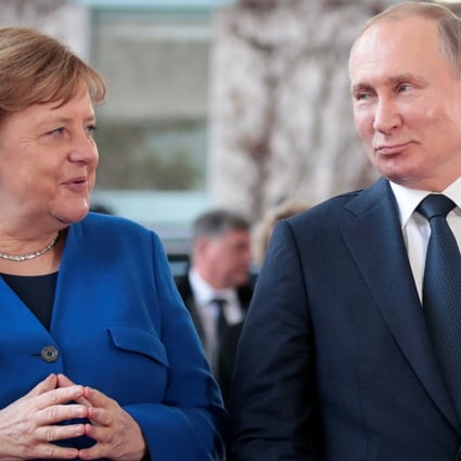 German Chancellor Angela Merkel and Russian President Vladimir Putin pose for a picture as he arrives to attend the Libya summit in Berlin in January 2020. Photo: Reuters