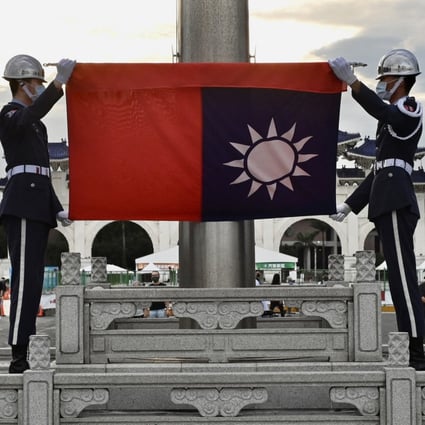 Honour guards fold the Taiwan flag during a ceremony in Taipei. Beijing has ramped up pressure on the island in recent years. Photo: AFP