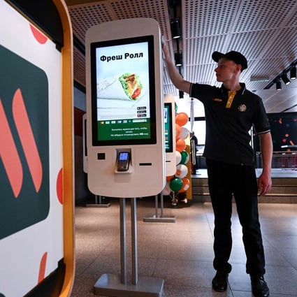 An employee cleans a self-ordering machine at the Russian version of a former McDonald’s restaurant in Moscow on June 12, 2022. Photo: AFP