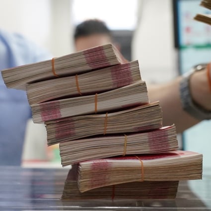 Bundles of yuan banknotes at the Ninja Money Exchange in the Shinjuku district of Tokyo on June 9. China’s economic woes, coupled with rising interest rates in the US and higher commodity costs, have caused a rapid depreciation of the renminbi against the US dollar. Photo: Bloomberg