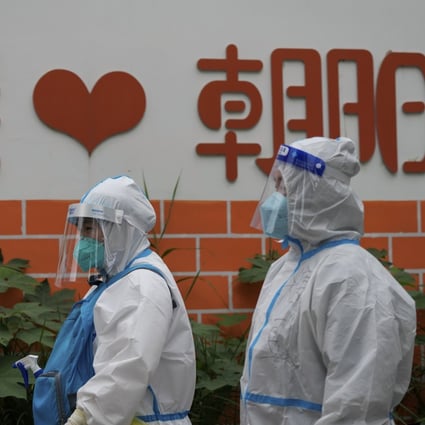 Medical workers in protective suits head to take Covid-19 samples from residents in Beijing. Photo: AP