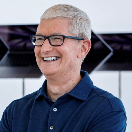 Apple chief executive Tim Cook poses in front of a row of new MacBook Airs running M2 chips on display at the opening of the tech giant’s annual Worldwide Developers Conference on June 6, 2022 at its headquarters in Cupertino, California. Photo: Reuters
