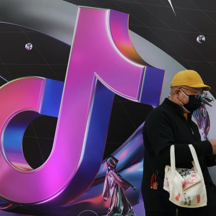 A man stands near a sign for ByteDance’s app TikTok, known locally as Douyin, in Beijing, March 31, 2021. Photo: Reuters