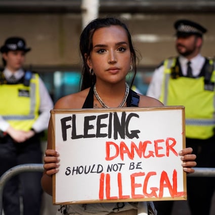 A protester outside the Home Office in central London. The British government was to send a first plane carrying failed asylum seekers to Rwanda on Tuesday. Photo: AFP 