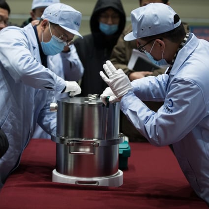 Researchers transfer a container loaded with moon samples retrieved by the Chang’e 5 probe in Beijing in December 2020. Photo: Xinhua