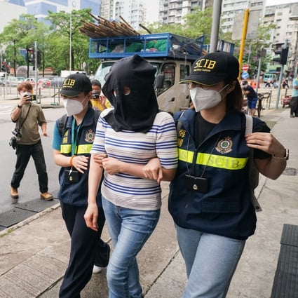 Customs officers arrest a woman in Jordan for allegedly laundering more than HK$350 million in suspected criminal proceeds. Photo: Felix Wong