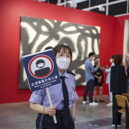 A security guard reminds visitors to wear face masks at all times in the Leo Gallery during a private viewing of Art Basel Hong Kong, held at the Hong Kong Convention and Exhibition Centre in Wan Chai on May 25. Photo: Nora Tam