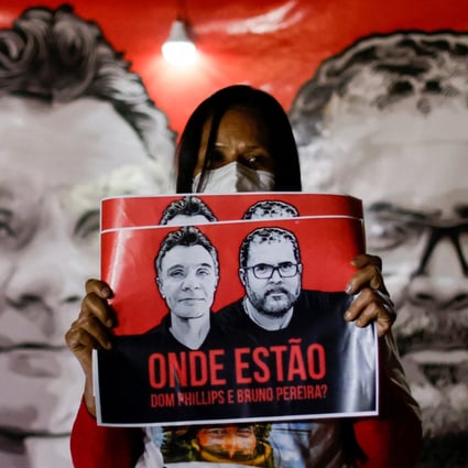 A demonstrator holds a sign during the search for missing British journalist Dom Phillips and indigenous expert Bruno Pereira, in Brasilia, Brazil on Wednesday. Photo: Reuters