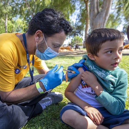A doctor administers a Covid-19 vaccine to a 5-year-old boy in Los Angeles. Photo: Los Angeles Times / TNS
