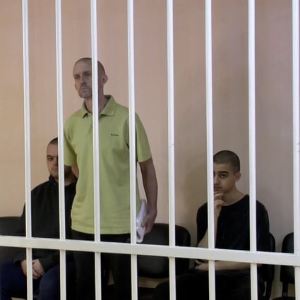From left, Britons Aiden Aslin, Shaun Pinner and Moroccan Brahim Saadoun, captured by Russian forces during a military conflict in Ukraine, at a location given as Donetsk, Ukraine in June. Photo: Supreme Court of Donetsk People’s Republic / Handout via Reuters TV