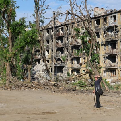 A resident walks past a damaged building in Mariupol, Ukraine, on Saturday. Photo: Xinhua