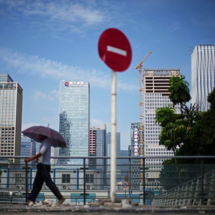 A man walks past a No Entry traffic sign near the headquarters of China Evergrande Group in Shenzhen, on September 26, 2021. Photo: Reuters