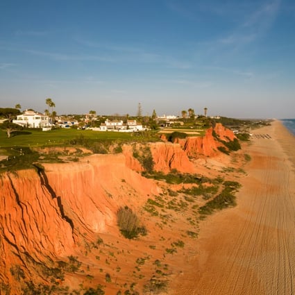 Golf courses next to a wide, empty beach look out over the water in Vale do Lobo, Algarve, Portugal. Such scenes have long made Portugal an attractive country for retirement. Photo: Getty Images