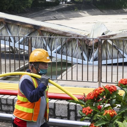 A CLP worker helps fix cables that caught fire in Yuen Long. Photo: K. Y. Cheng
