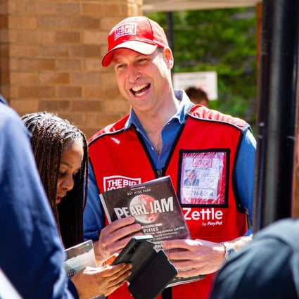 Britain’s Prince William poses for a picture with a vendor of The Big Issue newspaper to promote it s charitable cause in June. Photo: Reuters