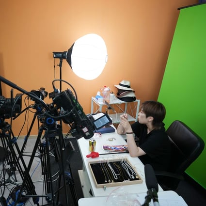 A staff member promotes pearl jewellery during a live-streaming sessions in Beijing. China has launched a new regulation on the live-streaming industry, requiring influencers to hold relevant qualifications to talk about certain topics. Photo: Xinhua