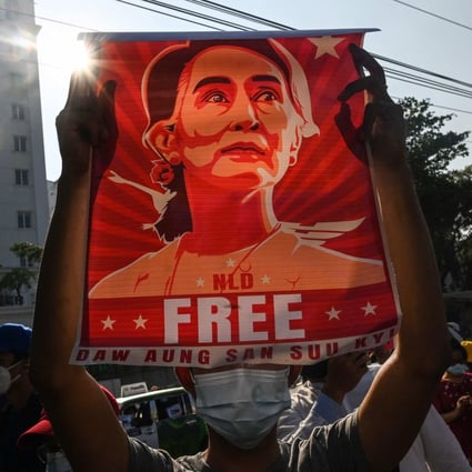 A protester holds up a poster featuring Aung San Suu Kyi during a demonstration in Yangon in 2021. File photo: AFP