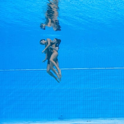 Anita Alvarez is recovered from the bottom of the pool by head coach Andrea Fuentes. Photo: AFP