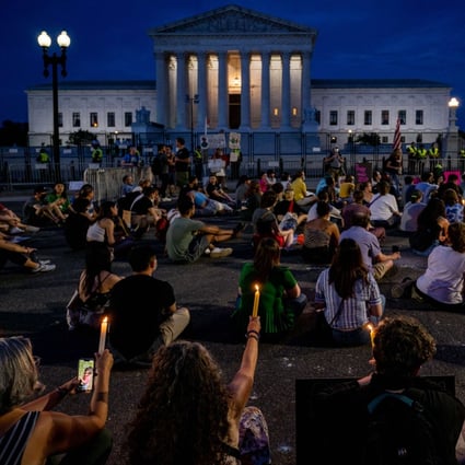Protesters attend a candlelit vigil in front of the US Supreme Court in Washington on June 26 to denounce the court’s decision to end federal abortion rights protections. Photo: AFP