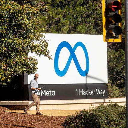 In this file photo taken on October 28, 2021, a man passes a newly unveiled logo for Facebook parent company Meta Platforms. Photo: AFP