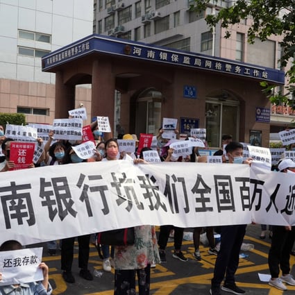 Protesters demand the return of their money in front of the Henan branch of the China Banking and Insurance Regulatory Commission in Zhengzhou city, central China’s Henan province. A cash crisis at four rural Henan banks highlights the vulnerability of rural lenders. Photo: Weibo