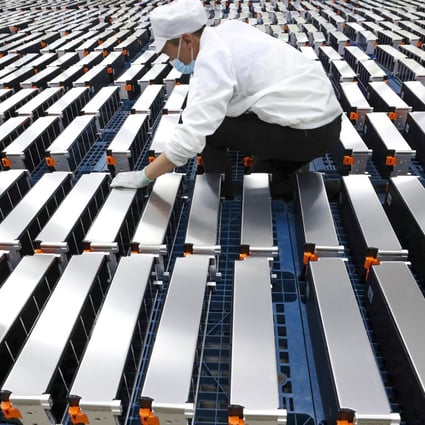 A worker with car batteries at a factory for Xinwangda Electric Vehicle Battery Co,  which makes lithium batteries for electric cars and other uses, in Nanjing Jiangsu province. Photo: AFP