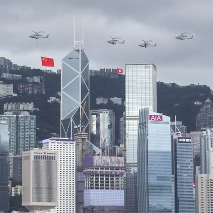 Helicopters flew China’s national flag and the Hong Kong Special Administrative Region’s standard over Central district to mark the 25th anniversary of Hong Kong’s handover to Chinese rule on 1 July 2022. Photo: Nora Tam.