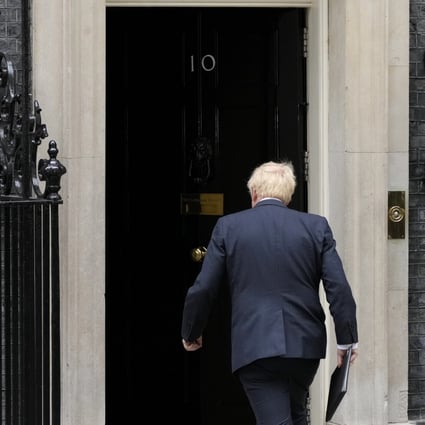 British Prime Minister Boris Johnson walks back inside 10 Downing Street after reading a resignation statement. Photo: AP