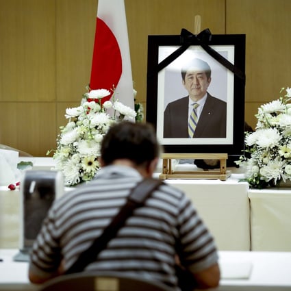 A man signs a book of condolence for former Japanese Prime Minister Shinzo Abe, who was killed on Friday, at the Japanese embassy in Thailand. Photo: EPA-EFE