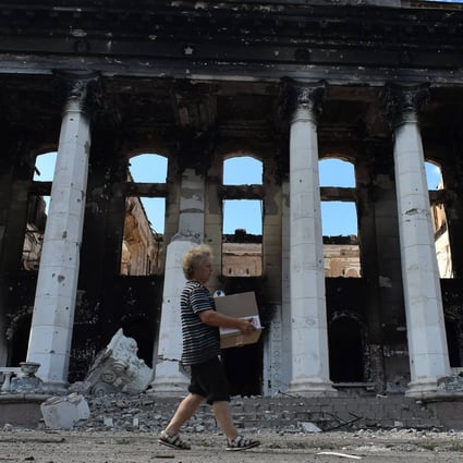 A resident walks past destroyed buildings in the city of Lysychansk, Ukraine, on July 12. Photo: AFP
