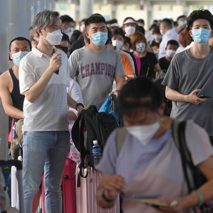Travellers queue up at the departure hall of Shenzhen Bay Port. Officials warned of rather long waits for Covid-19 tests at the Shenzhen Bay Control Point, urging travellers to avoid going there until later in the day.   10JUL22   SCMP / Sam Tsang