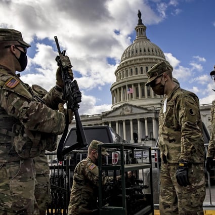 National Guard troops are issued rifles and ammunition outside the US Capitol building in January last year. The State Partnership Programme is run by the US National Guard. Photo: Samuel Corum/Getty Images/TNS