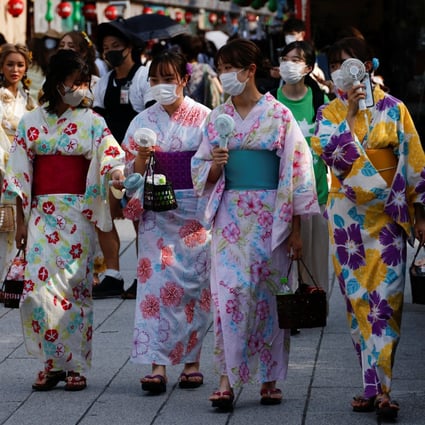 Women wearing summer kimonos use portable fans as they walk in the Asakusa district of Tokyo on June 29. Japan’s investigation of the weight and dietary habits of young women is tainted by its framing as a matter of ensuring healthy babies. Photo: Reuters